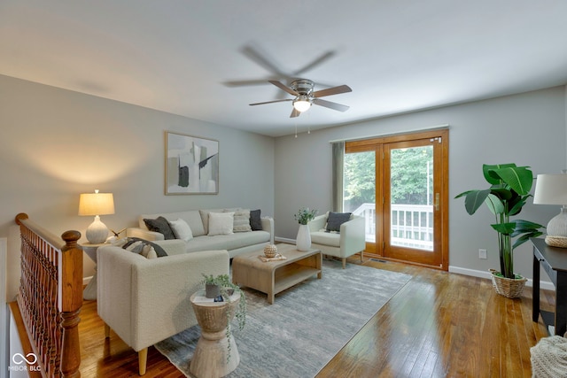 living room featuring ceiling fan and wood-type flooring