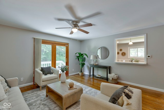 living room featuring ceiling fan and light wood-type flooring