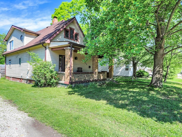 view of front of property featuring a front lawn and a chimney