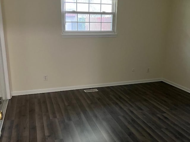 unfurnished room with dark hardwood / wood-style floors