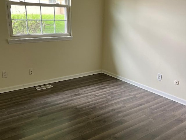 unfurnished room featuring dark wood-type flooring