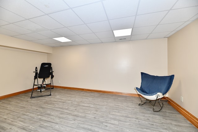 living area featuring hardwood / wood-style floors and a drop ceiling