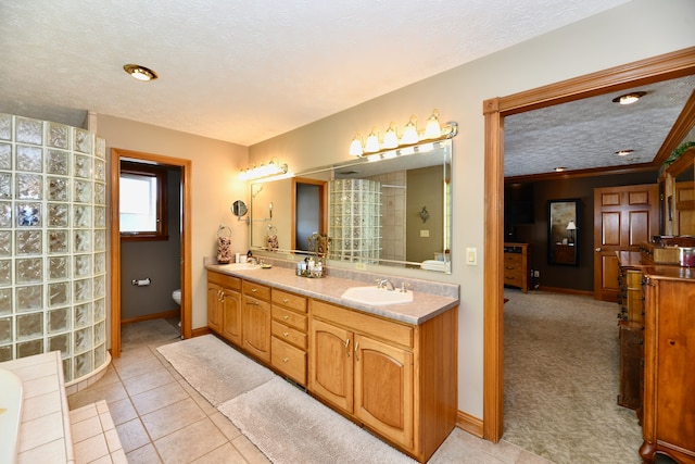 bathroom featuring tile floors, double sink vanity, a textured ceiling, and toilet