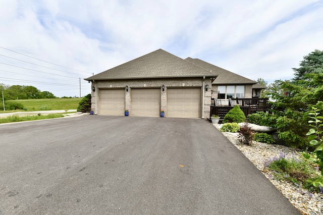 view of front of house featuring a wooden deck and a garage