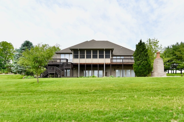 back of house with a lawn and a wooden deck