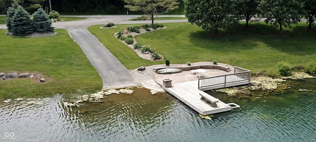 dock area featuring a water view and a lawn