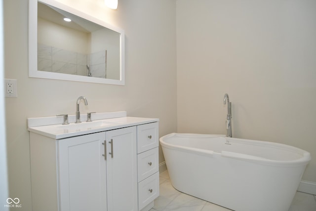 547 Udell St, Indianapolis, IN 46208 - bathroom featuring a freestanding tub, vanity, baseboards, and marble look tile flooring