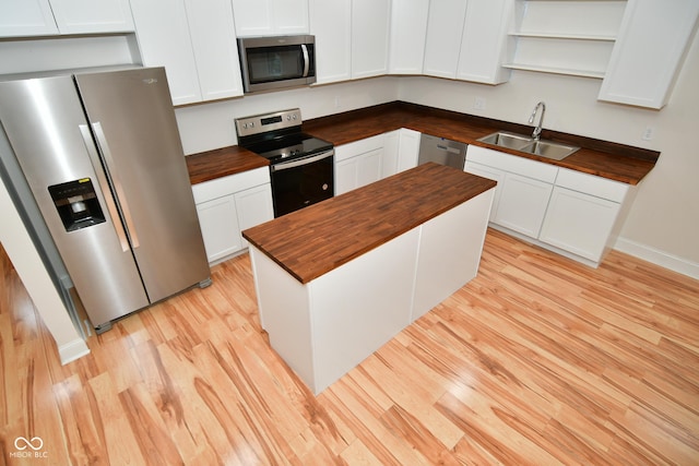 547 Udell St, Indianapolis, IN 46208 - kitchen featuring wooden counters, appliances with stainless steel finishes, a sink, and light wood-style floors