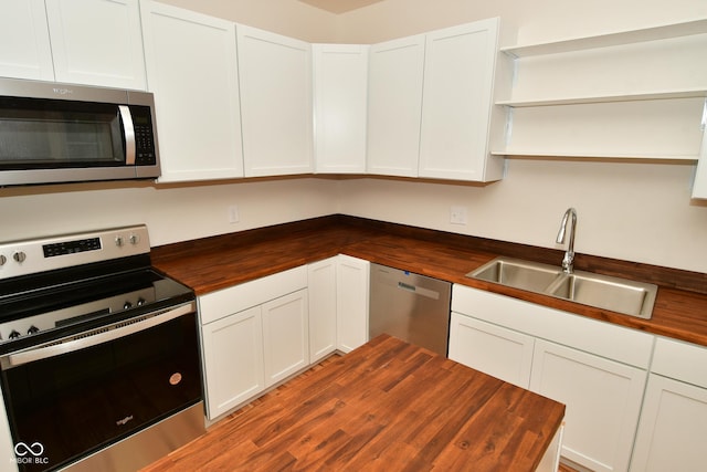 547 Udell St, Indianapolis, IN 46208 - kitchen featuring butcher block countertops, appliances with stainless steel finishes, a sink, and open shelves