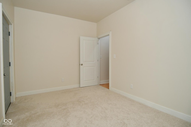 547 Udell St, Indianapolis, IN 46208 - unfurnished bedroom featuring light carpet and baseboards