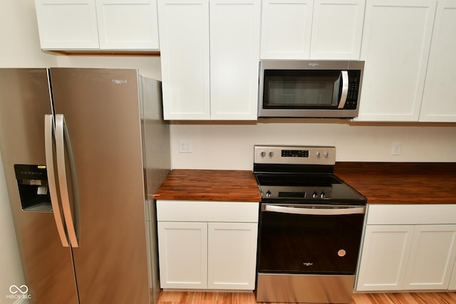 547 Udell St, Indianapolis, IN 46208 - kitchen featuring stainless steel appliances, wood counters, and white cabinetry