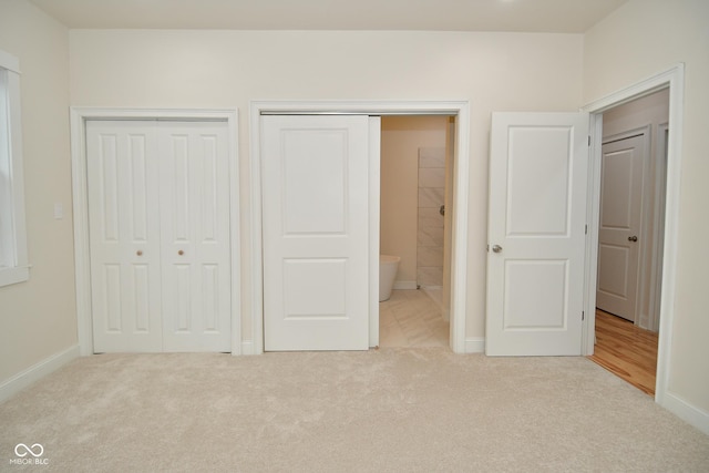 547 Udell St, Indianapolis, IN 46208 - unfurnished bedroom featuring carpet, baseboards, and multiple closets