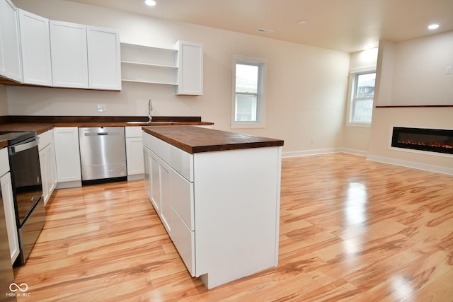 547 Udell St, Indianapolis, IN 46208 - kitchen with butcher block counters, dishwasher, light wood-type flooring, electric range, and healthy amount of natural light