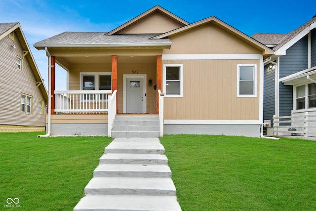 547 Udell St, Indianapolis, IN 46208 - view of front of house featuring covered porch, a front lawn, and roof with shingles