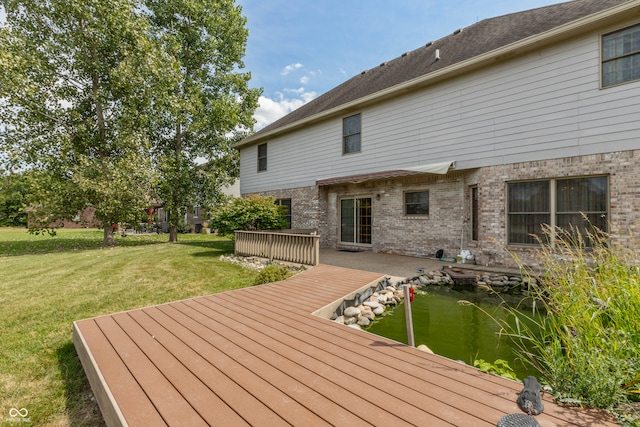 wooden terrace featuring a yard