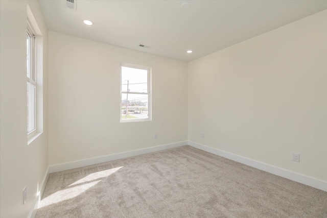 unfurnished room featuring light colored carpet