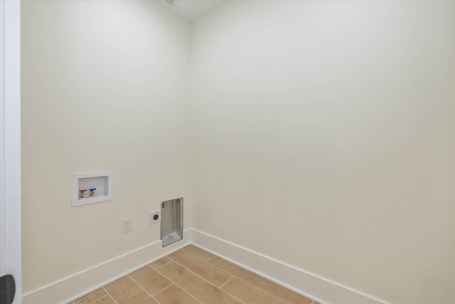 clothes washing area featuring light hardwood / wood-style flooring, hookup for a washing machine, and electric dryer hookup