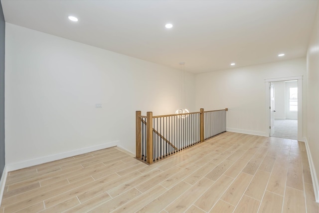 spare room featuring light hardwood / wood-style floors