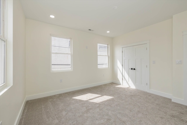 empty room with light colored carpet