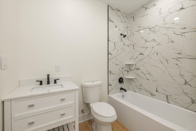 full bathroom with toilet, vanity, and tiled shower / bath