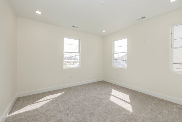 empty room featuring light colored carpet