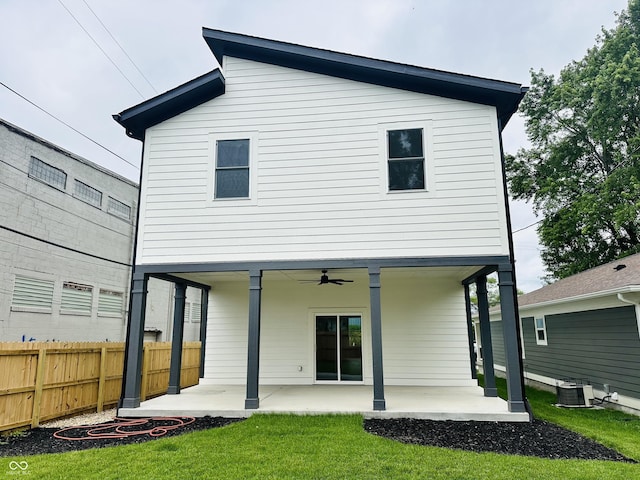 back of property featuring central AC unit, a lawn, a patio, ceiling fan, and fence