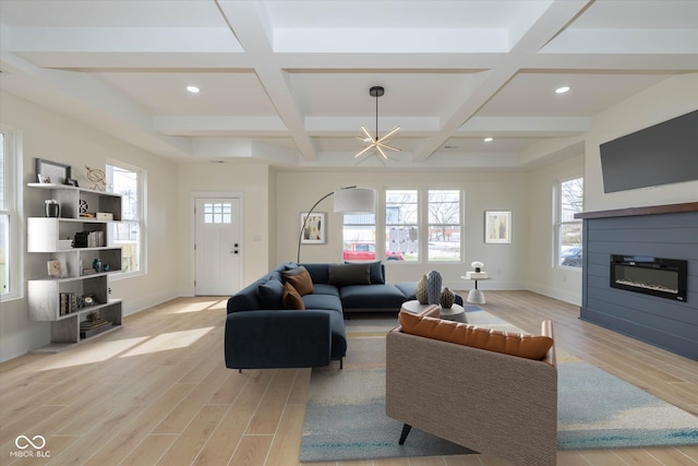 living room featuring coffered ceiling, light hardwood / wood-style floors, a notable chandelier, and beam ceiling