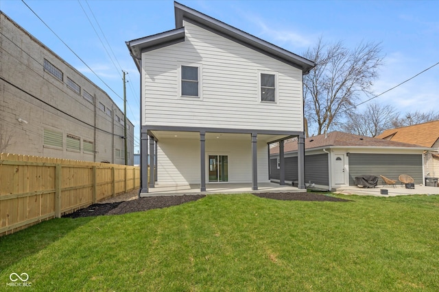 rear view of property with a patio area and a yard