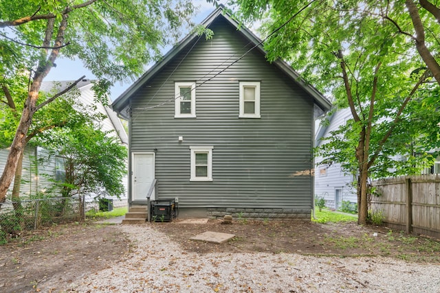 back of house featuring central AC