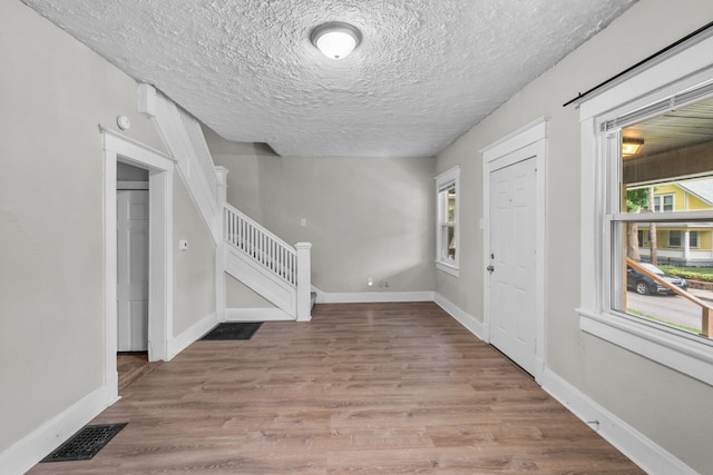 entrance foyer featuring a textured ceiling and hardwood / wood-style floors