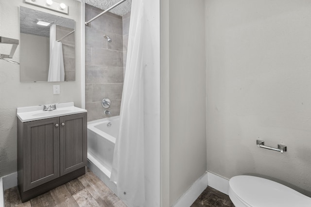 full bathroom with a textured ceiling, toilet, vanity, hardwood / wood-style flooring, and shower / bathtub combination with curtain