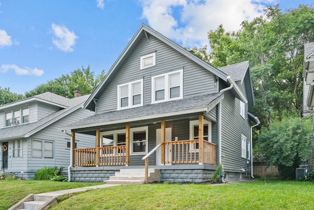 view of front of home with central AC, a porch, and a front yard