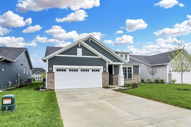 craftsman-style house with a garage, central AC unit, and a front lawn