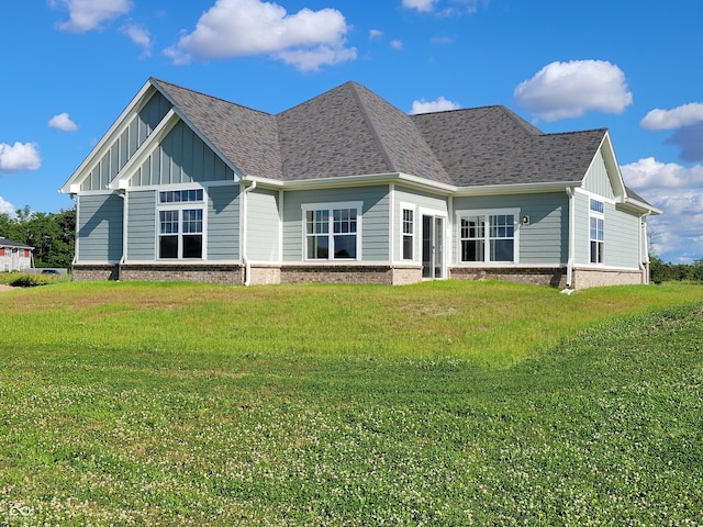 back of property featuring a lawn