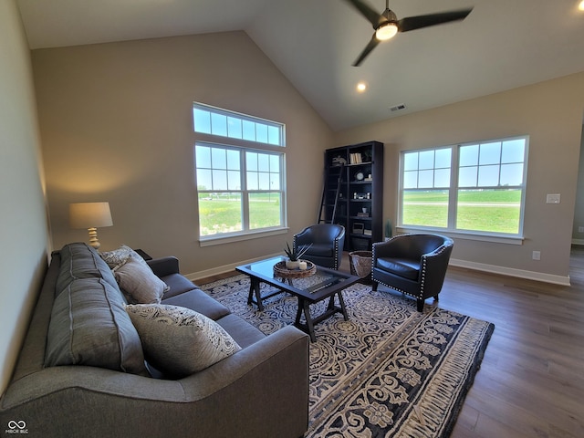 living room featuring ceiling fan, wood-type flooring, and vaulted ceiling