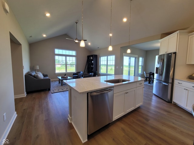 kitchen featuring white cabinets, dark hardwood / wood-style flooring, stainless steel appliances, and a kitchen island with sink