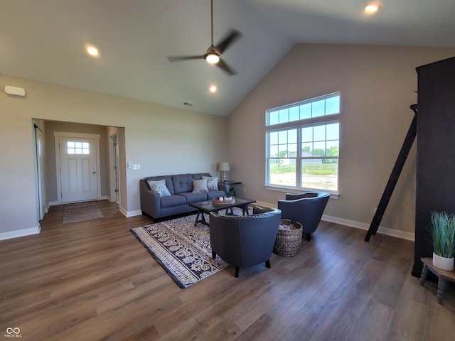 living room featuring hardwood / wood-style floors, high vaulted ceiling, and ceiling fan