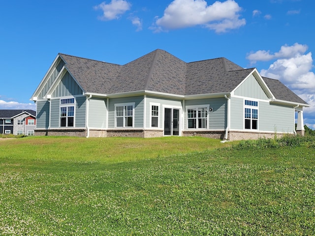 rear view of property featuring a yard