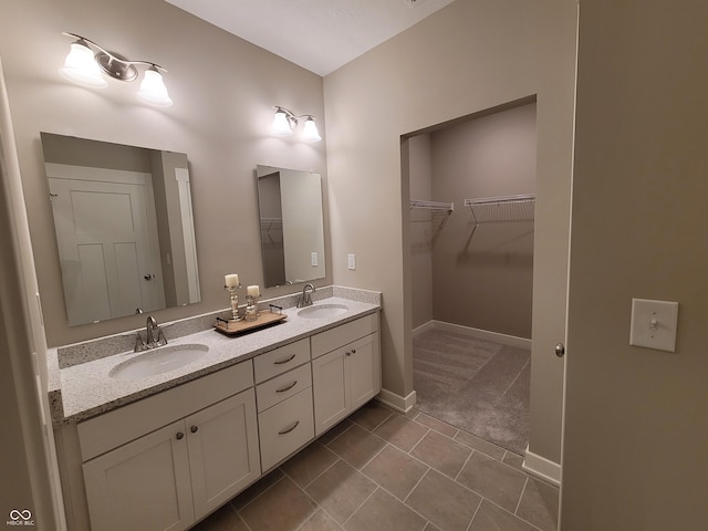 bathroom featuring tile patterned flooring and vanity