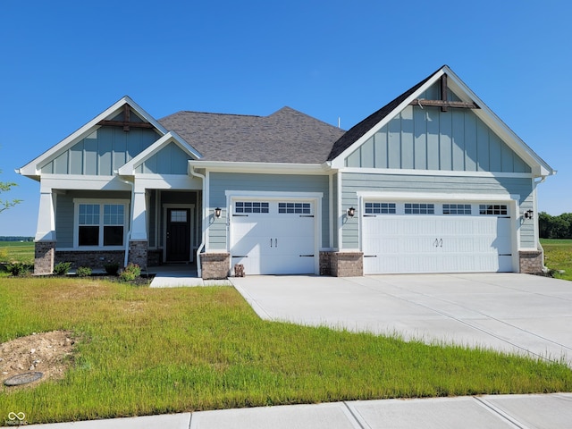 craftsman-style home featuring a front lawn and a garage