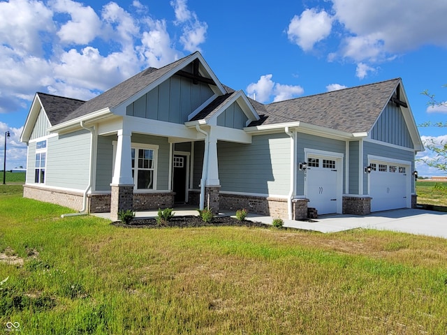 craftsman house with a porch, a garage, and a front yard