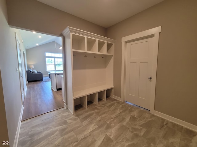 mudroom with light hardwood / wood-style floors and vaulted ceiling