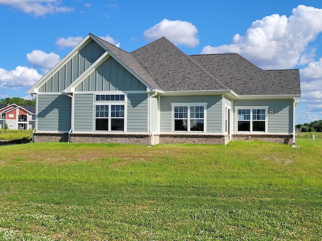 back of property featuring a yard