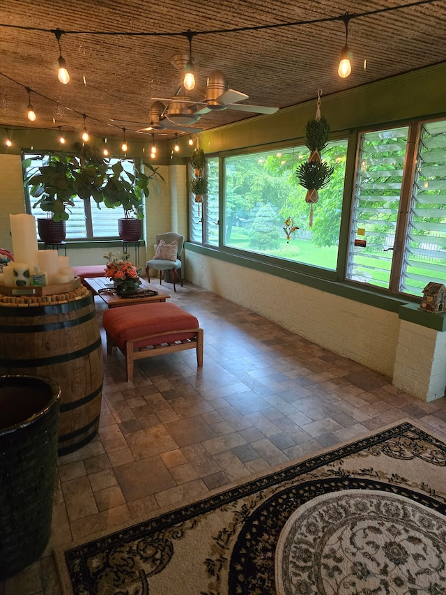 sunroom / solarium featuring a chandelier