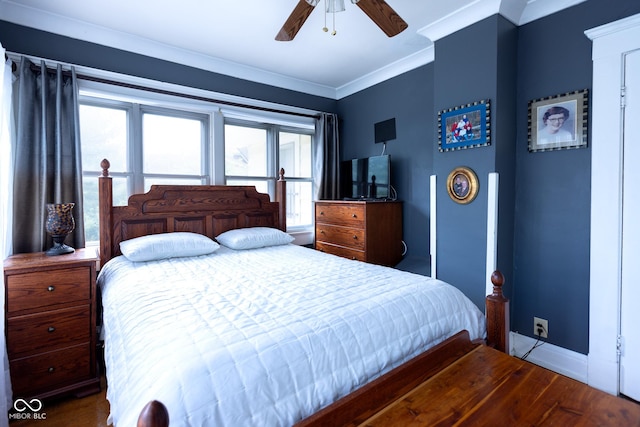 bedroom featuring ceiling fan, wood-type flooring, crown molding, and multiple windows