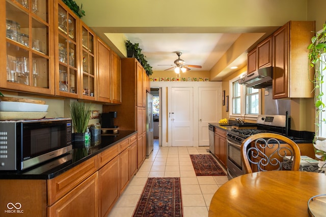 kitchen with appliances with stainless steel finishes, sink, ceiling fan, and light tile patterned flooring