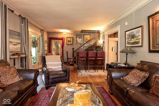 living room with hardwood / wood-style flooring and ornamental molding