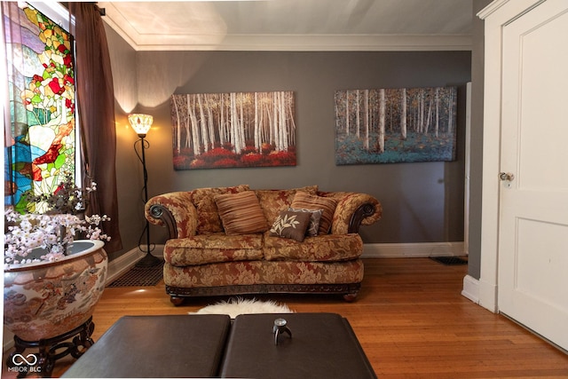 living room with wood-type flooring and ornamental molding