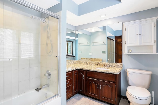 full bathroom with vanity, shower / bath combination with glass door, and toilet