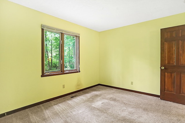 unfurnished room with light colored carpet